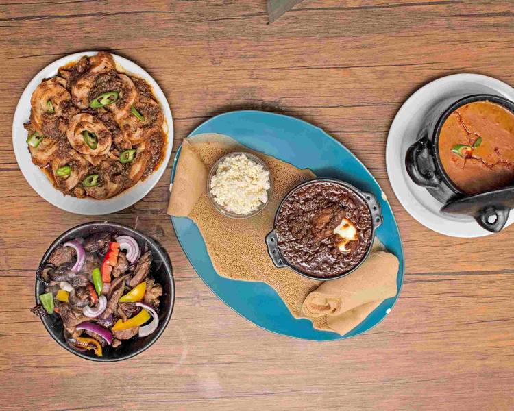 A selection of Fidel Habesha dishes, with injera, rich stews and sautéed meat